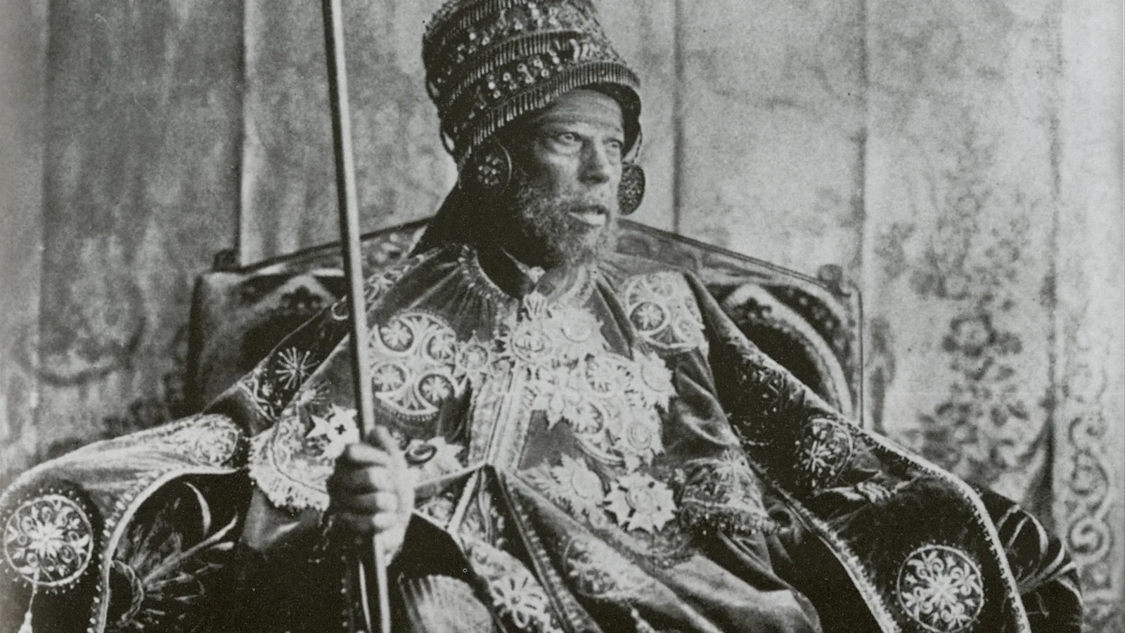 Emperor Menelik II seated on his throne in coronation robes and crown