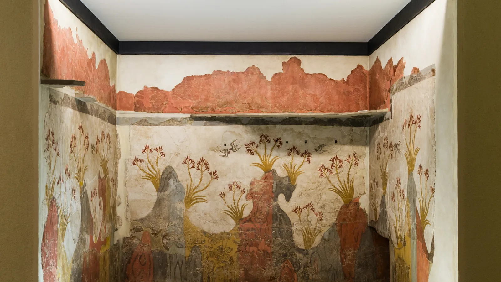 a wall painting of red rocky outcrops, white lilies and swallows in flight