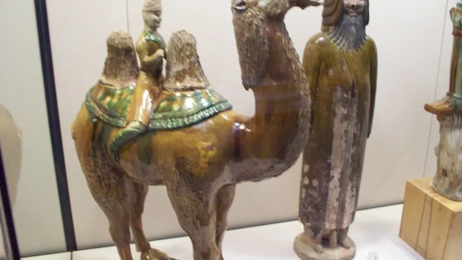 a glazed ceramic camel of the Tang dynasty in brown and green