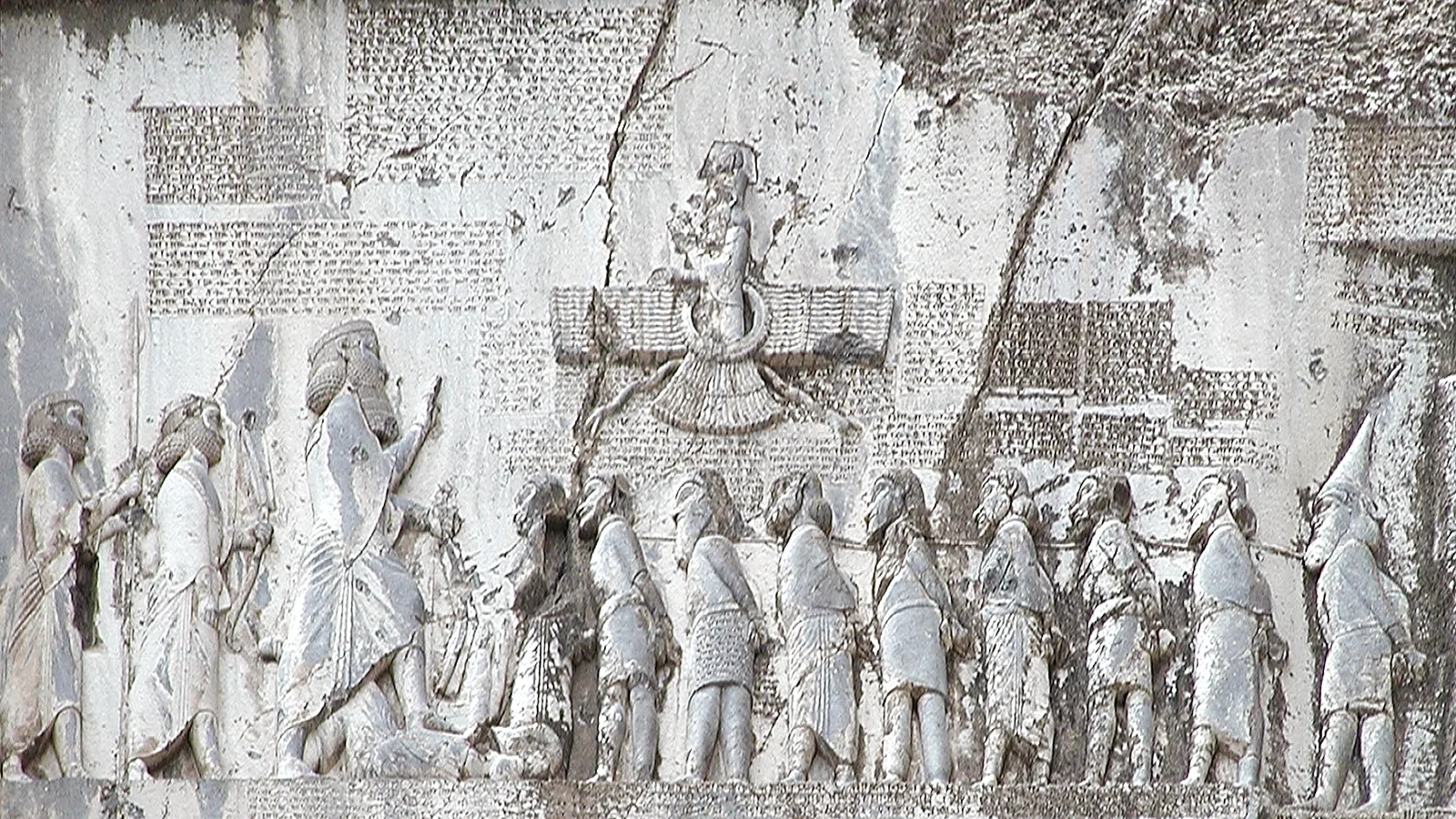 Rock relief and cuneiform inscription panel carved into the Bisotun cliff face