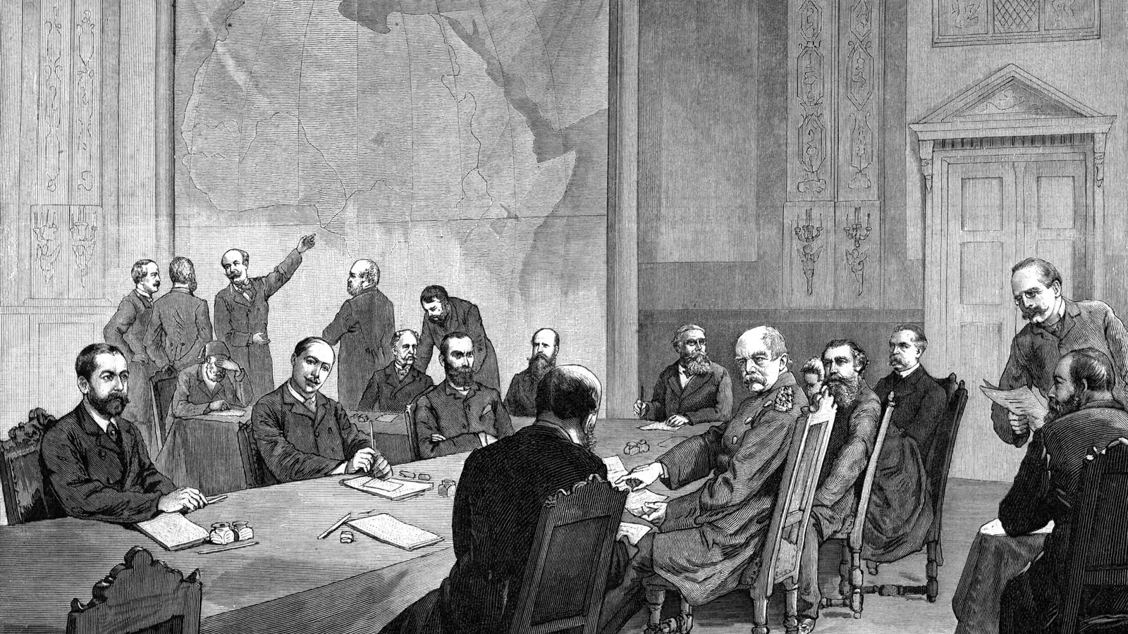 a 19th-century engraving of men in frock coats seated around a long table with a wall map