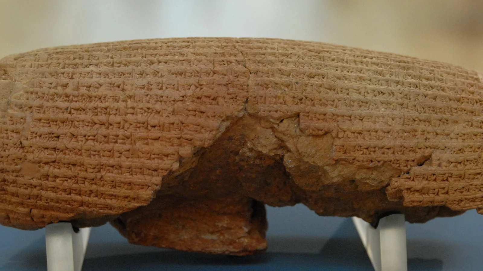 Close view of the cylinder's cuneiform lines and the damaged area of its surface