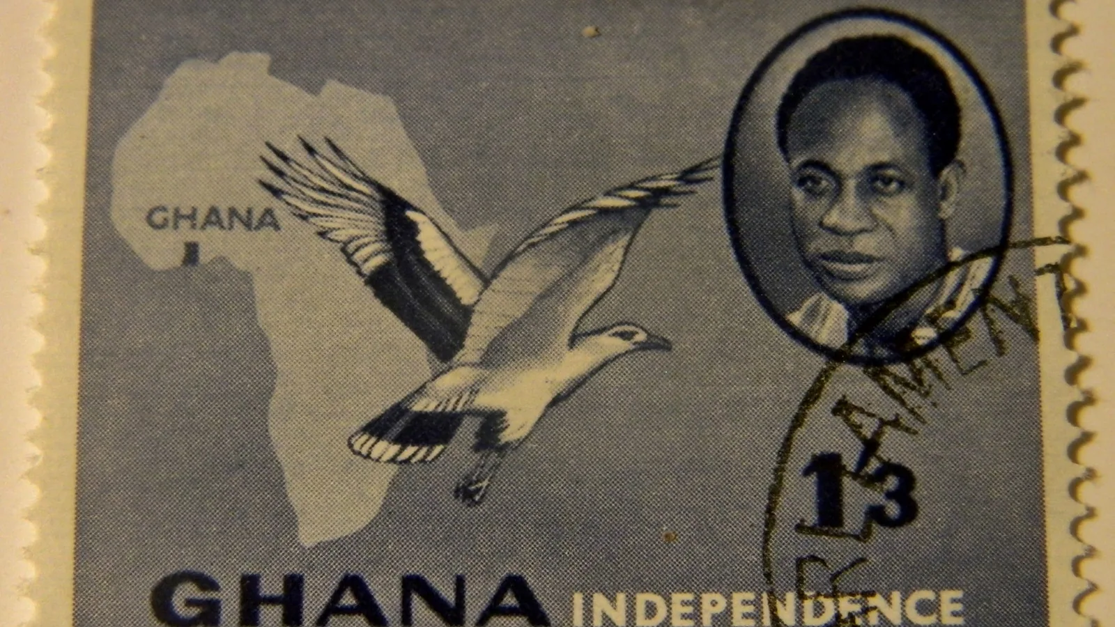 a postage stamp showing a portrait of Kwame Nkrumah beside an outline map of Ghana
