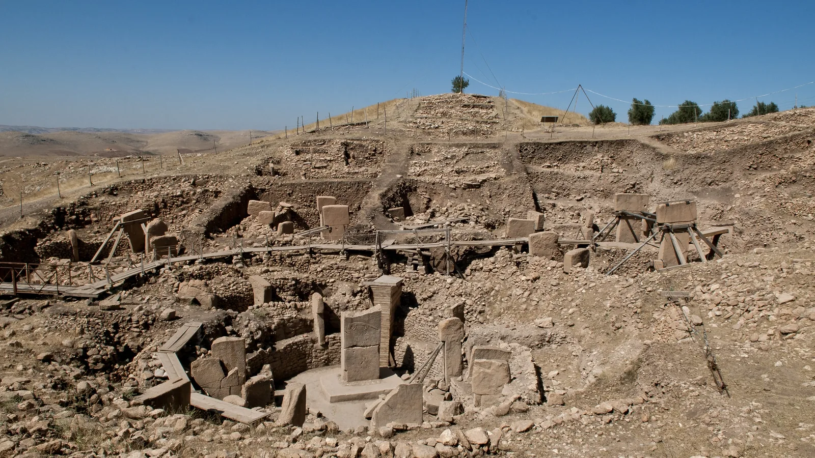 a ring of T-shaped limestone pillars set in a stone-walled enclosure on an excavated hillside