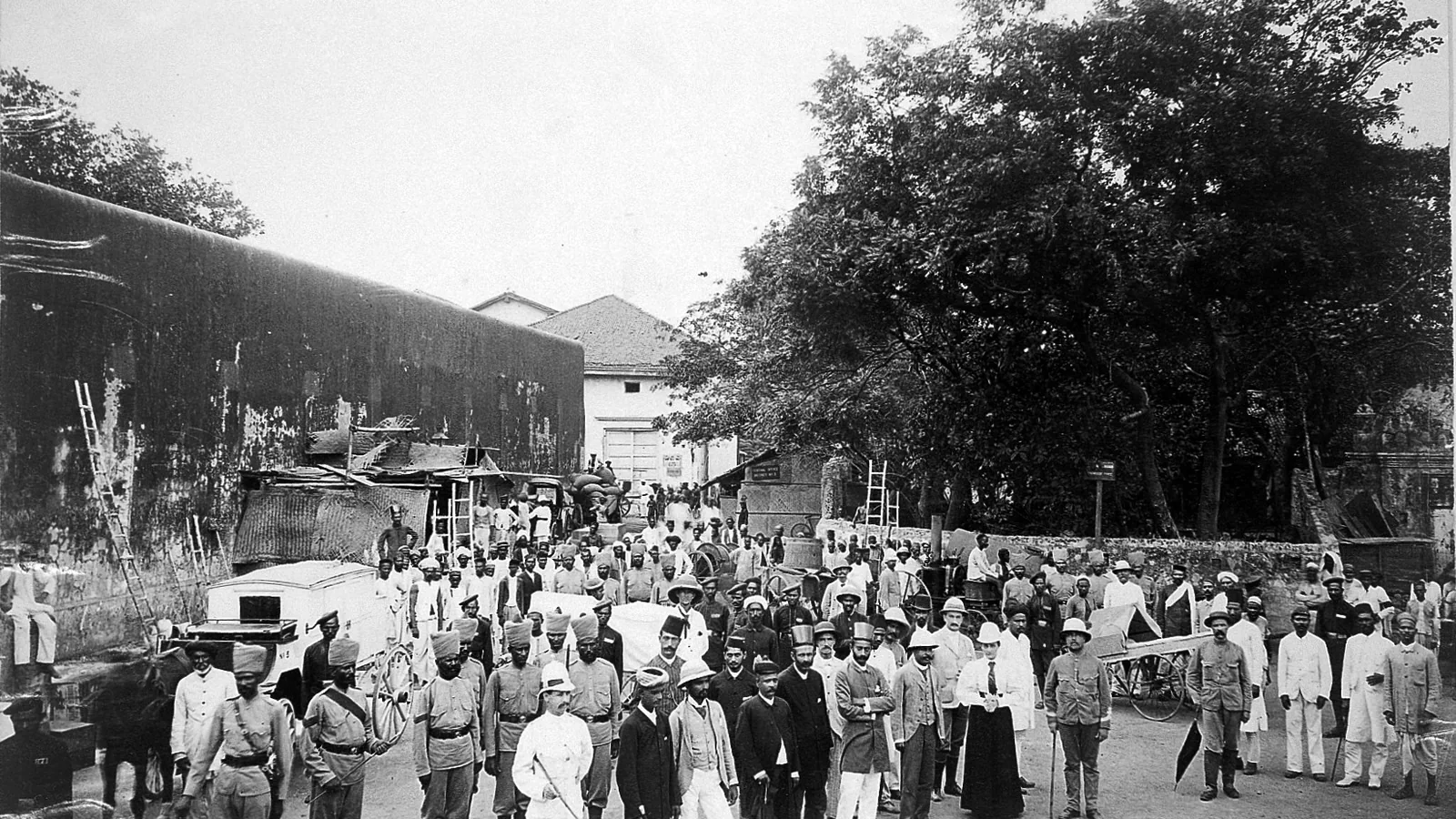 Group of doctors and officials gathered on a street before starting the day's work