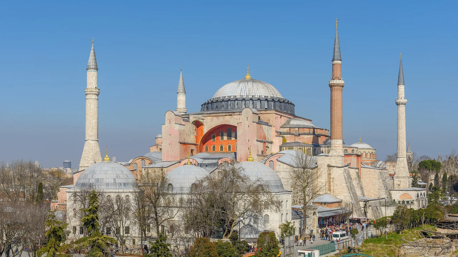 a large domed building with four slender minarets seen from a raised viewpoint