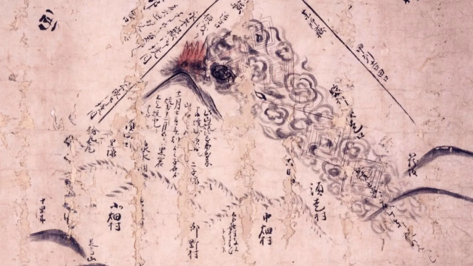 Edo-period ink drawing of Mount Fuji as a triangle, with the eruption plume and nearby place names marked near the crater.