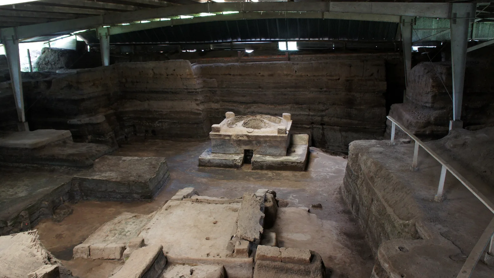 Excavated sweat-bath structure with volcanic ash layers visible in the surrounding walls