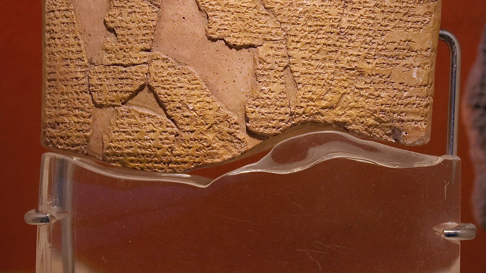 A smaller cuneiform tablet of the Kadesh treaty with a fragment beside it, in a museum case