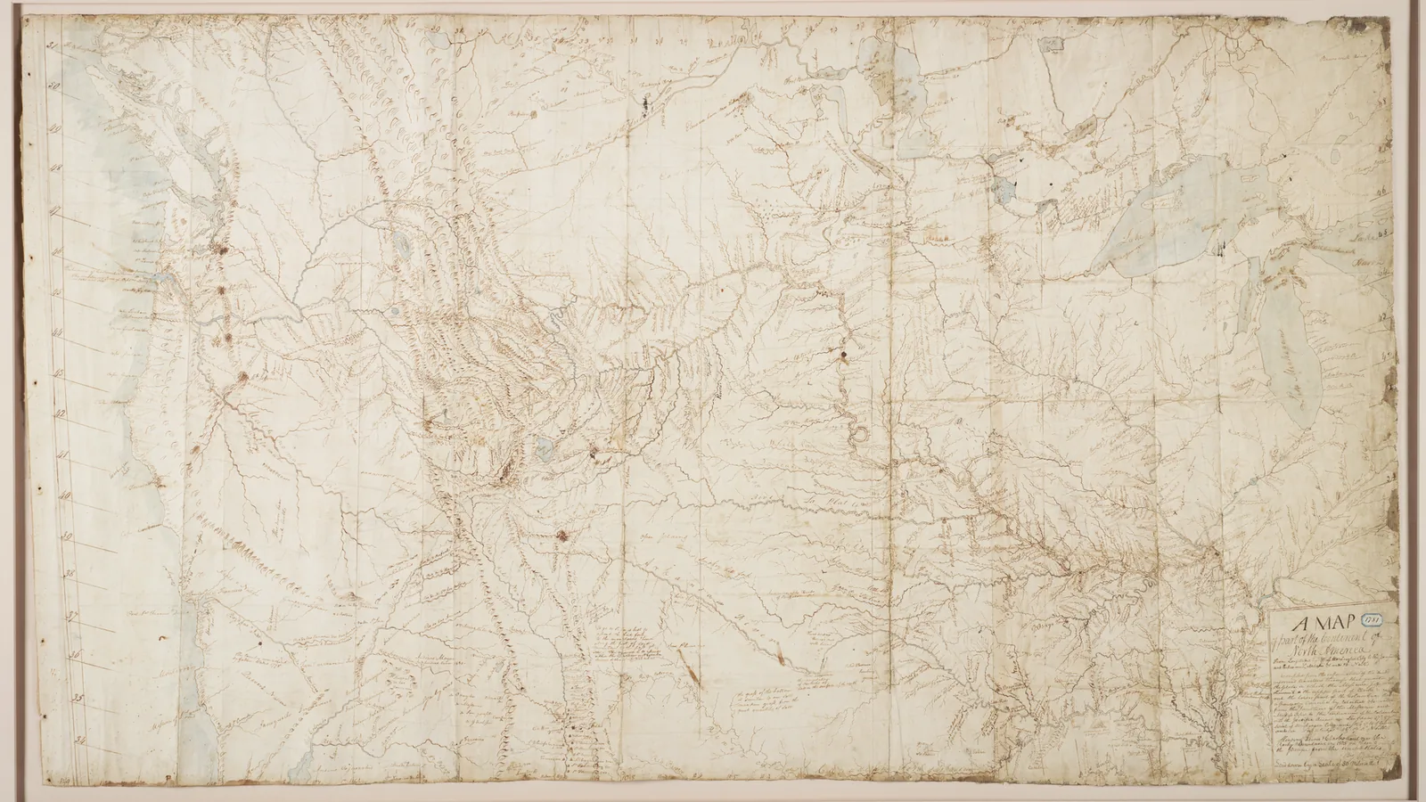 a large hand-drawn manuscript map on yellowed paper, faint river courses and mountain ranges in brown ink