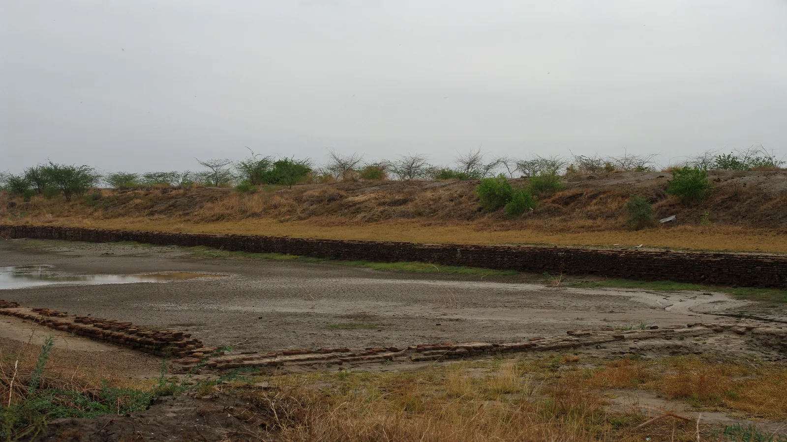 Close view of the dry brick walls and floor at one corner of the Lothal basin