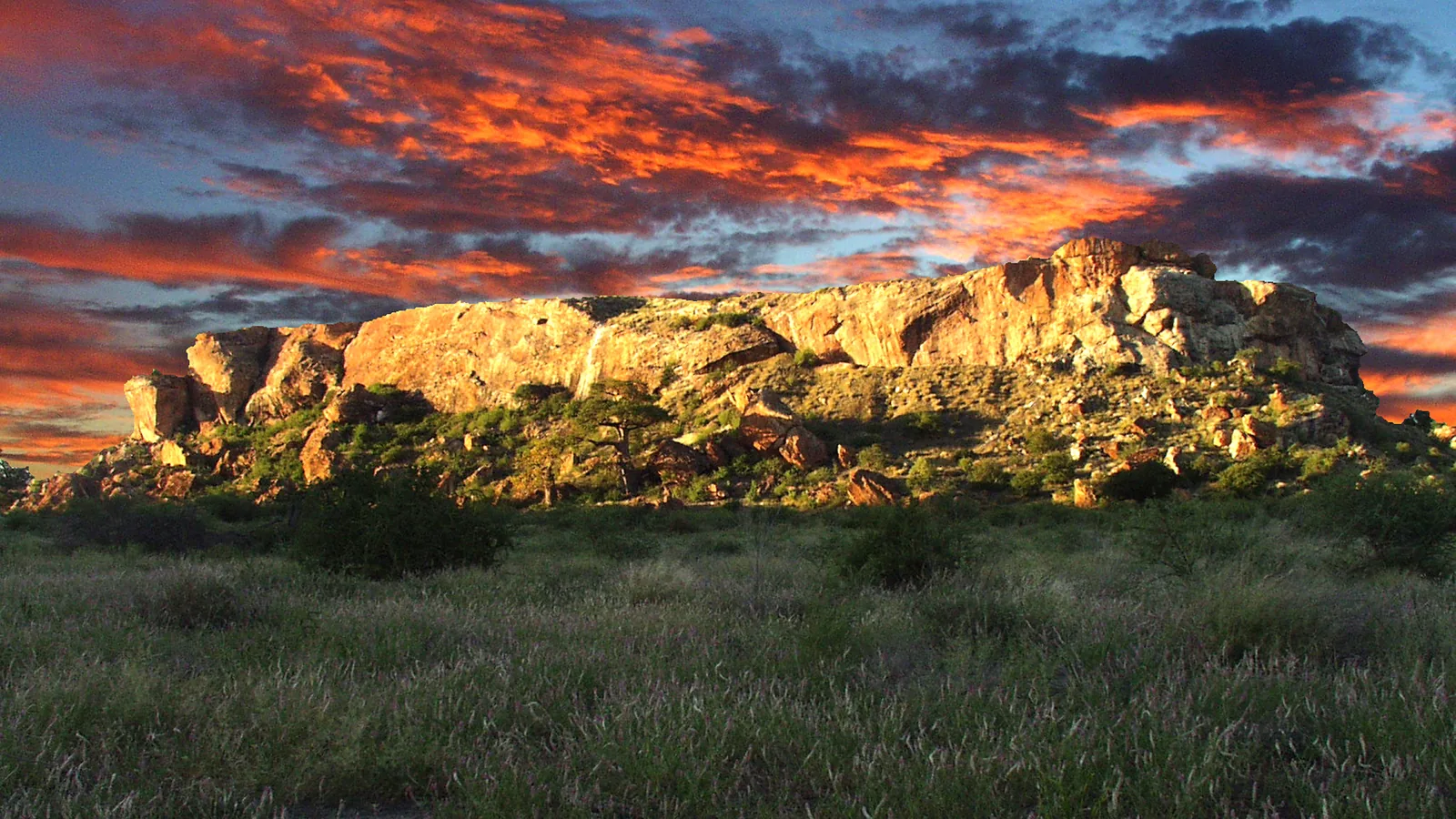 Flat-topped sandstone hill rising above the surrounding savanna
