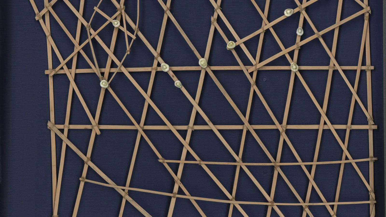 A wooden stick chart with curved sticks and shells used for Marshallese ocean navigation