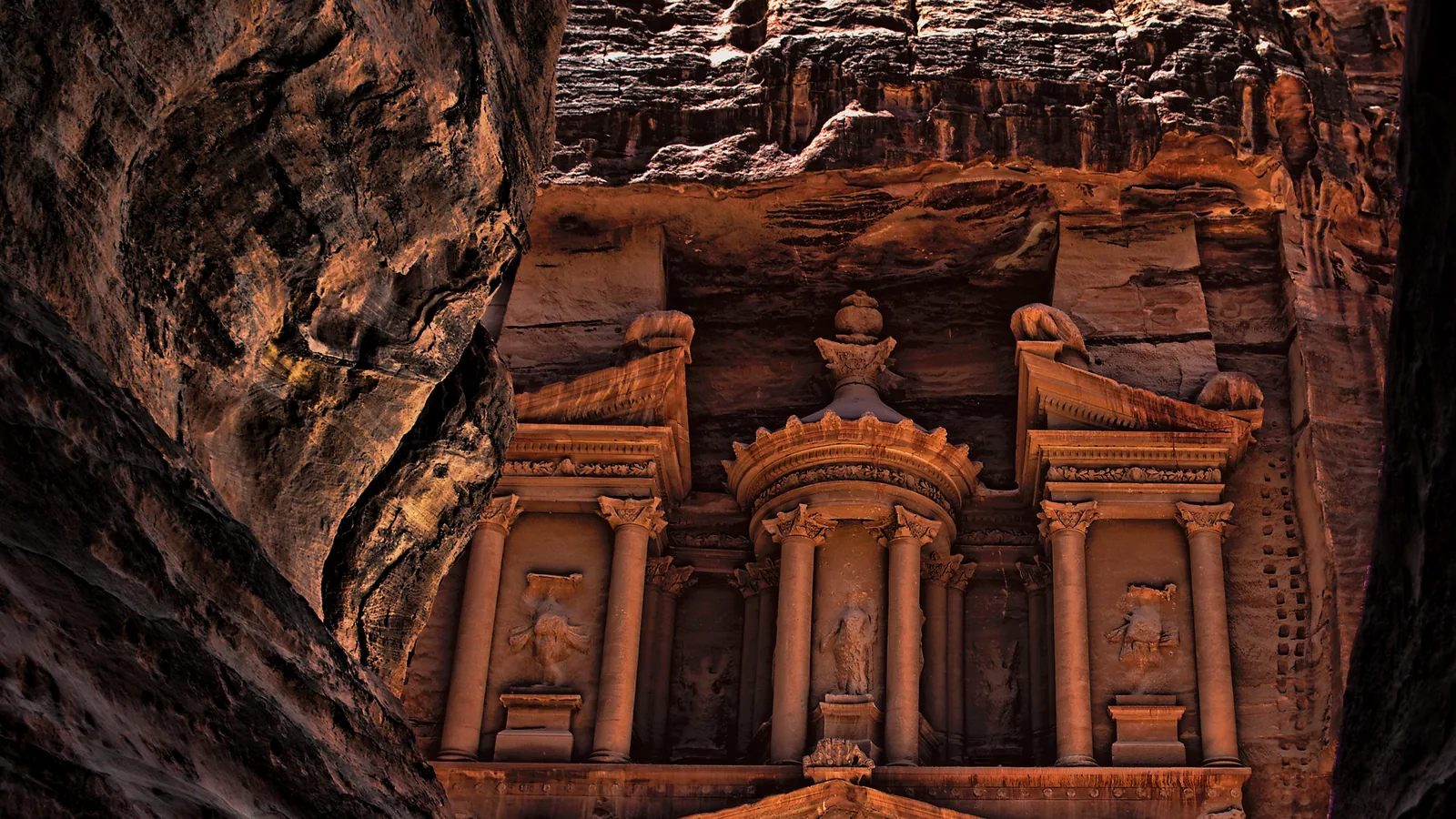 Rock-cut facade of Al-Khazneh with columns and a broken pediment
