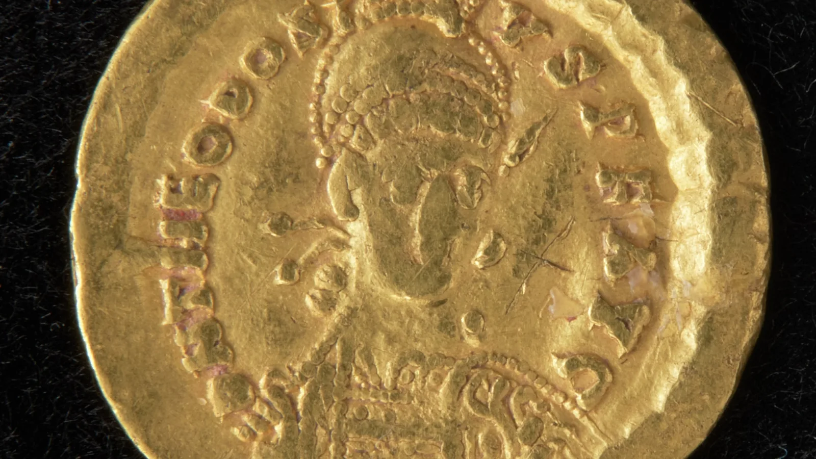Gold coin with a diademed bust of Byzantine emperor Theodosius II in profile