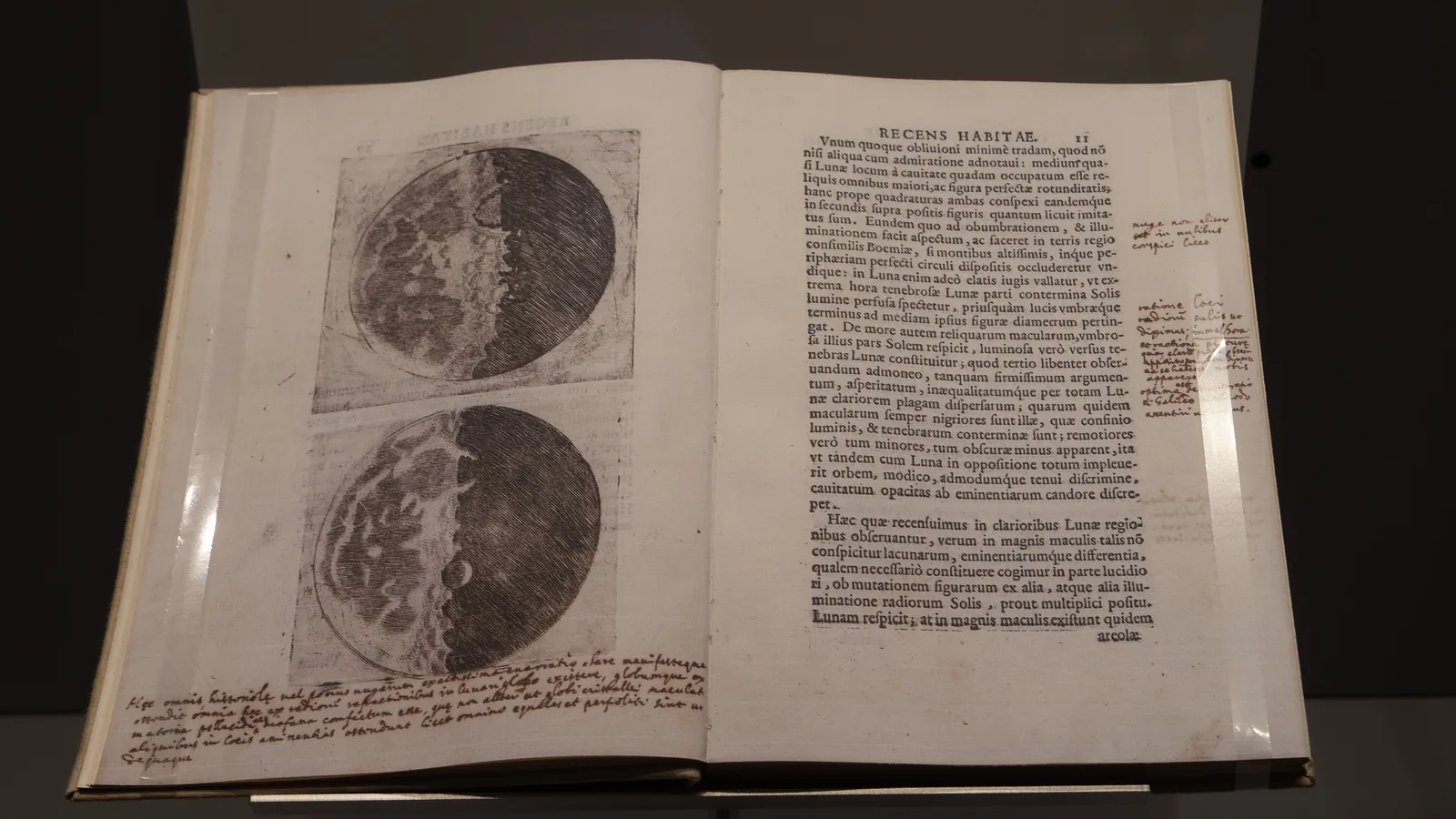 an open printed book of 1610 with Latin text and etched drawings of the Moon