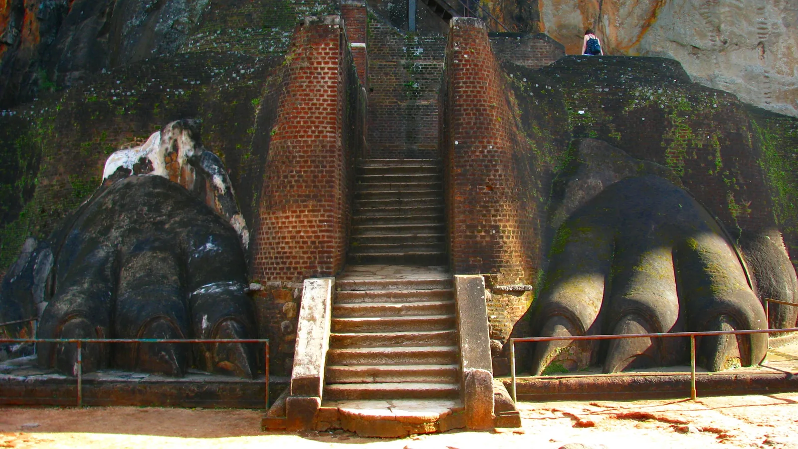 Two large carved lion paws flanking a stone staircase on Sigiriya rock