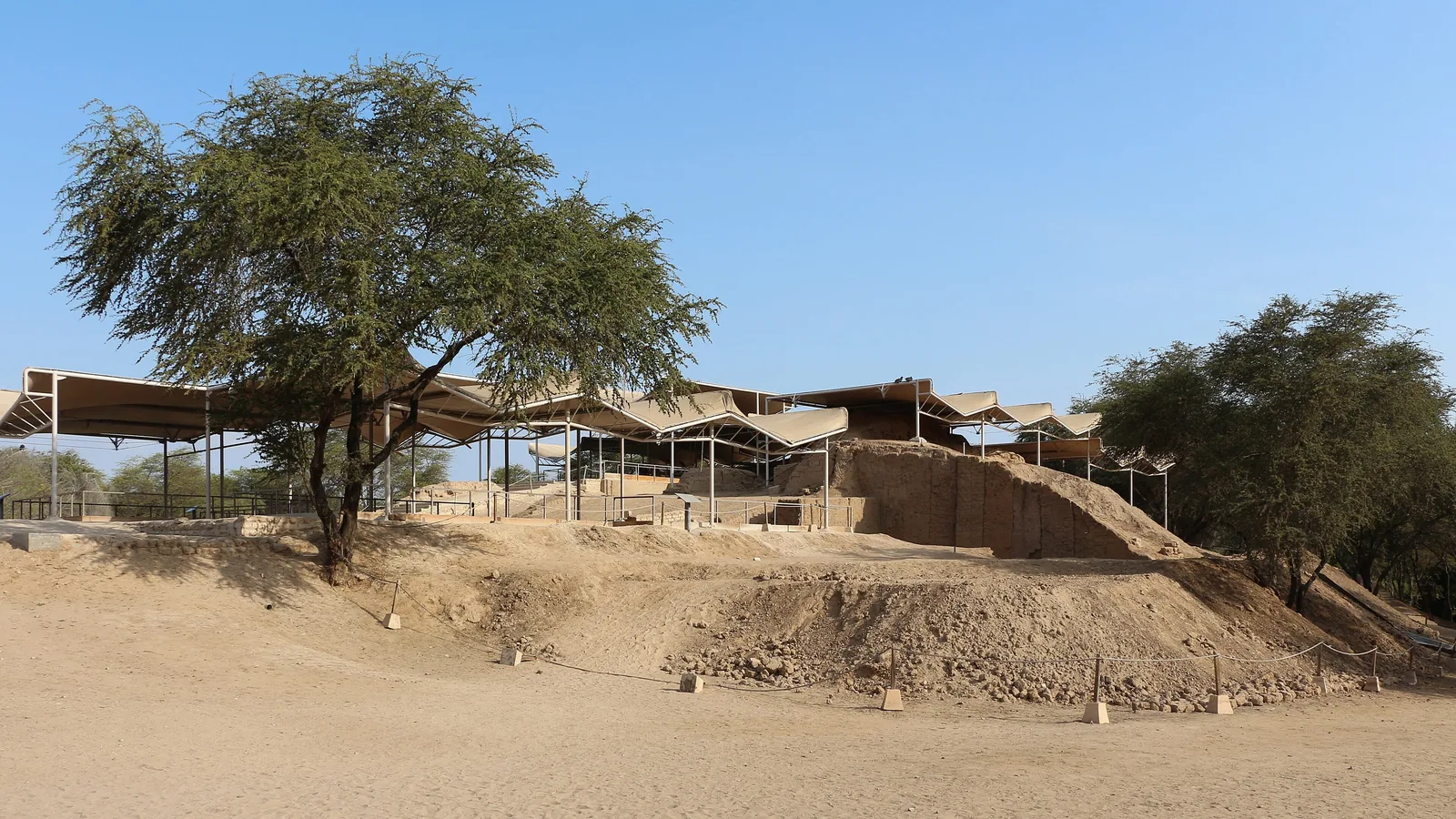 Adobe platform mound covered by a canopy roof at an excavated archaeological site