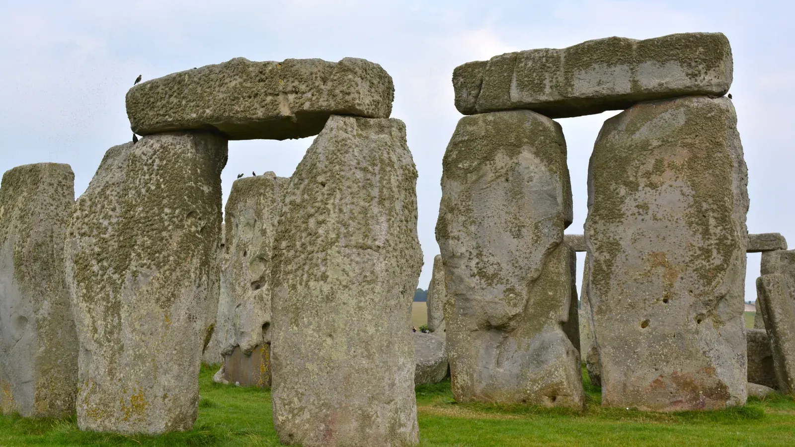 two sarsen trilithons of Stonehenge against a cloudy sky