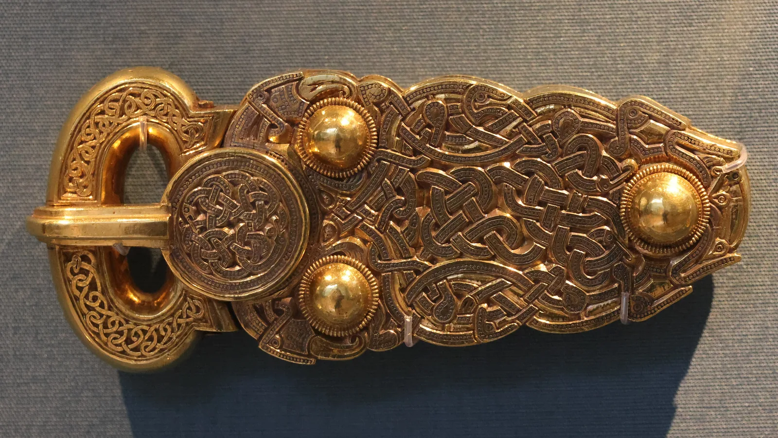 A large gold belt buckle with interlace animal decoration from the Sutton Hoo ship burial