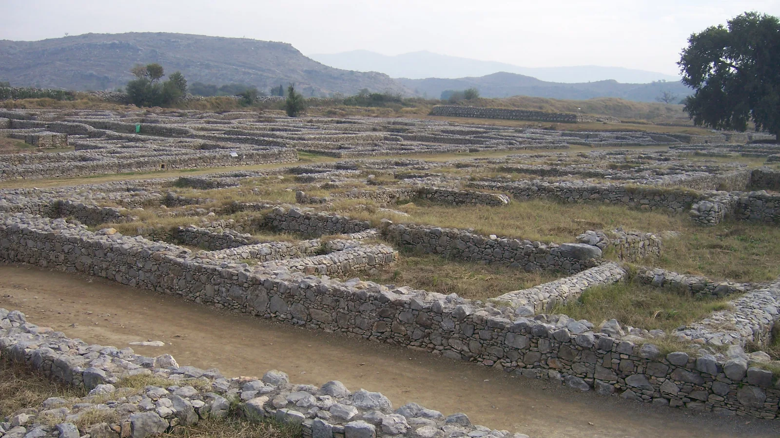 Stone wall ruins of an ancient city site under an open sky