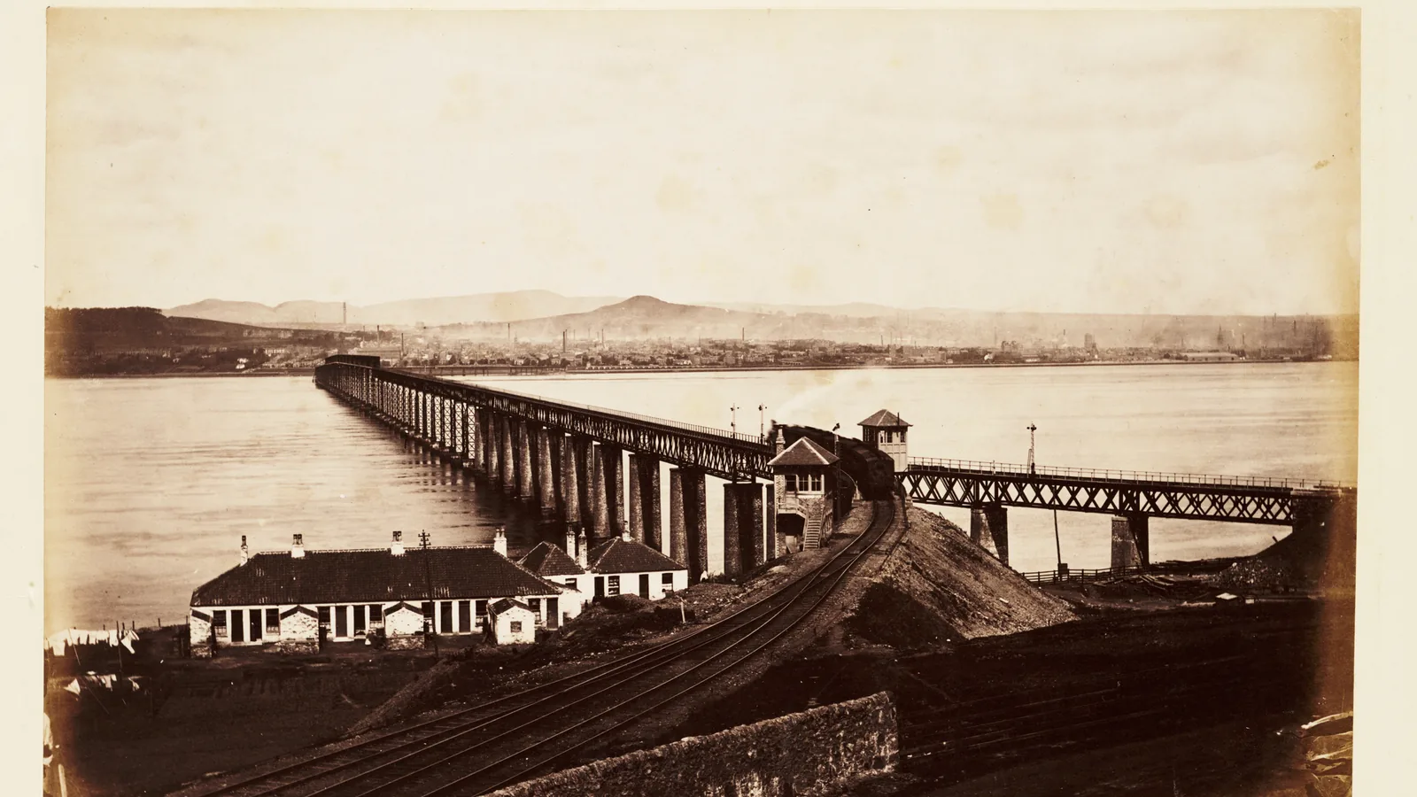 The original Tay Bridge with a steam train crossing, photographed from the south end near Wormit