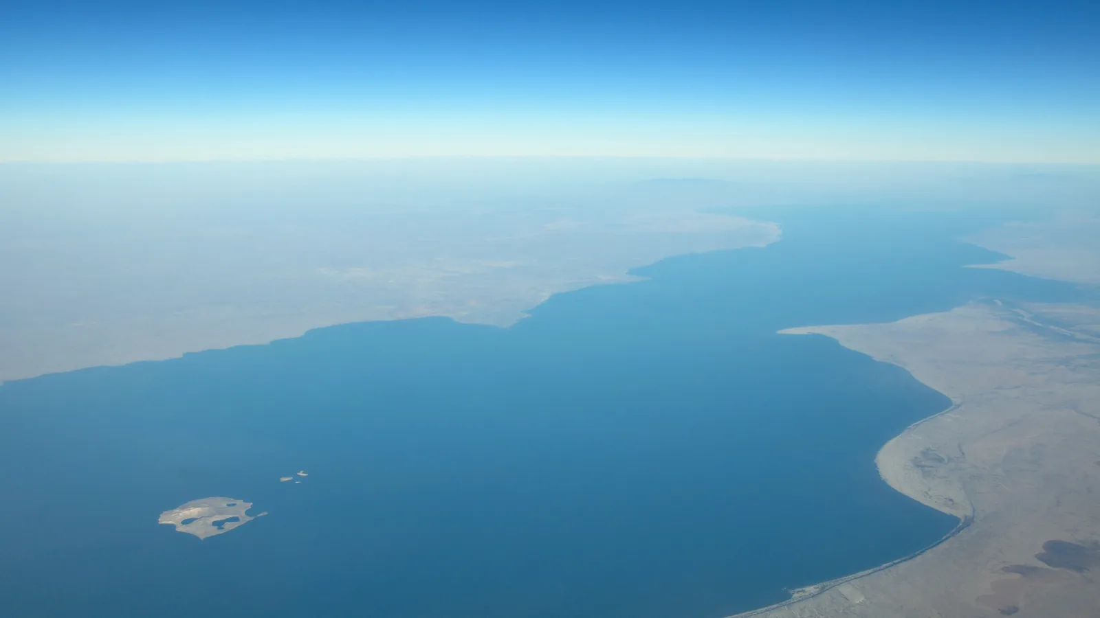 an aerial view of Lake Turkana's shoreline and arid surrounding landscape