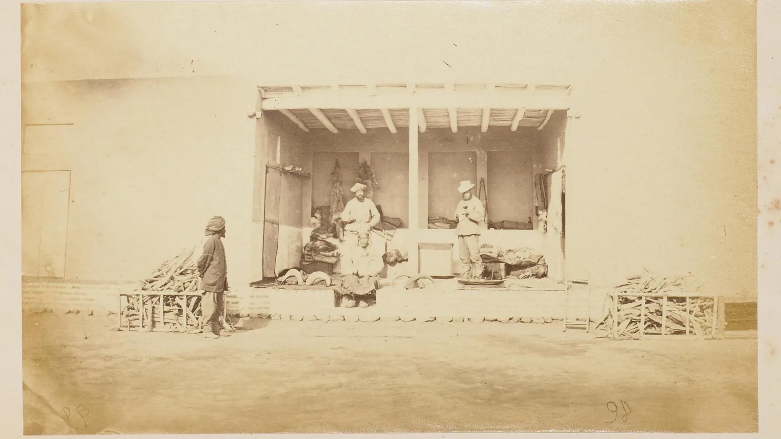 Two European mission members seated outside a tent at winter quarters in Kashgar