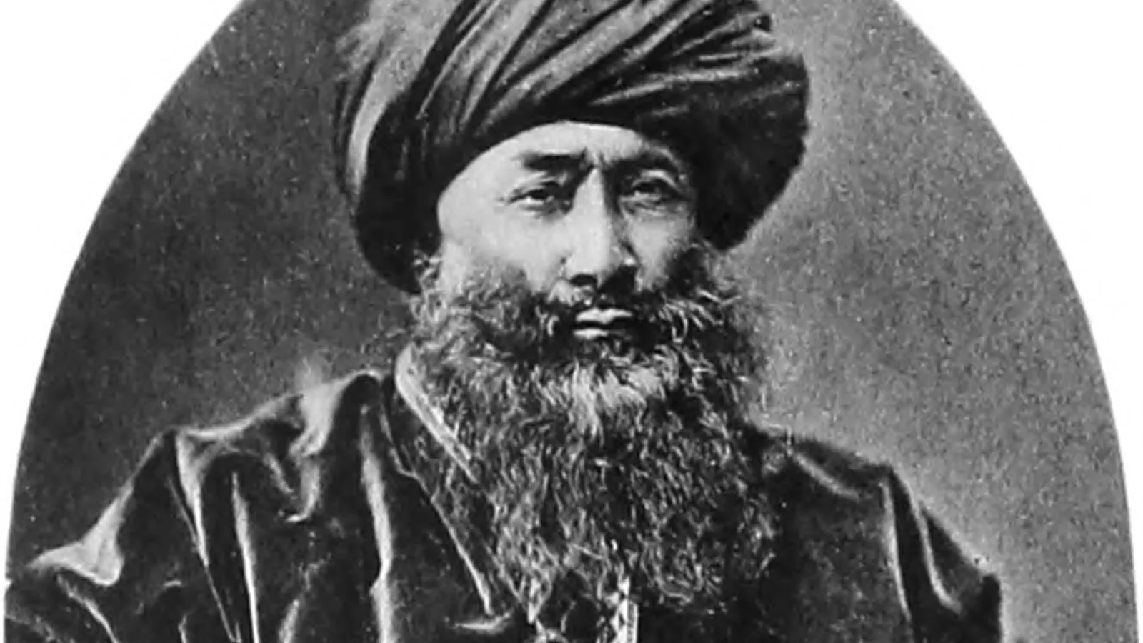 a printed portrait of a bearded man in a turban and robe, seated